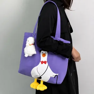 Detail of purple canvas tote bag with cartoon goose print and yellow 3D feet decoration