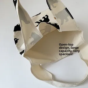 Close-up of cream canvas tote bag showing open-top design and large capacity interior
