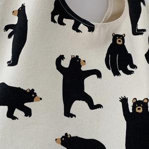 Close-up of durable canvas fabric showing high-quality black bear print and twill texture