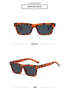 Detail view of tortoiseshell rectangle sunglasses with metal accents and dark lenses