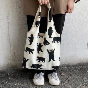 Off-white canvas tote bag featuring cute all-over black cartoon bear prints for women