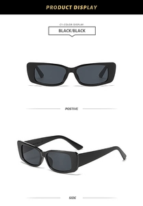 Détail de lunettes de soleil rectangulaires noires avec monture en plastique minimaliste