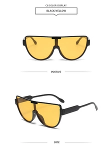 Detailansicht der Halbrand-Oversize-Sonnenbrille mit schwarzem Rahmen und gelben Gläsern