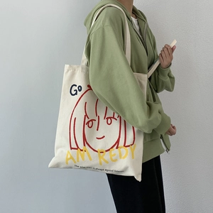 Artistic off-white canvas tote bag with red portrait and blue graphic text illustration