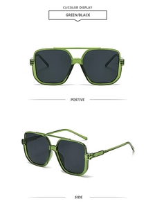 Detail view of stylish square aviator sunglasses with green frames and dark lenses