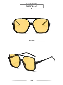 Detail view of square black sunglasses with yellow lenses and double bridge design