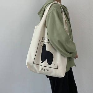 Detail of off-white canvas tote bag featuring alpaca print and minimalist black frame design