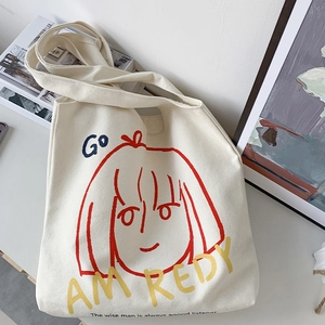 Detail of cream canvas tote bag with artistic girl portrait and vibrant slogan
