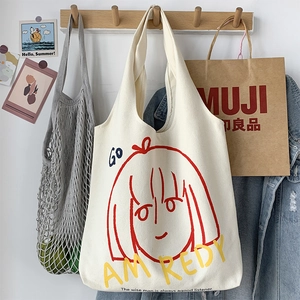 Close-up of cream canvas tote bag featuring minimalist red line art girl illustration