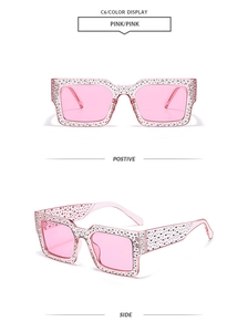 Detail view of pink square sunglasses featuring sparkling rhinestone-encrusted frames