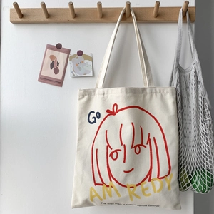 Detail of artistic canvas tote bag featuring a minimalist line girl graphic print