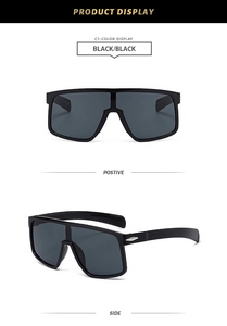 Detail view of large frame cycling sunglasses with silver metal accents and gray lenses