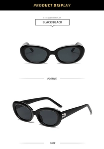 Detail of vintage oval cat eye sunglasses with sleek black frame and silver hinge metal accents