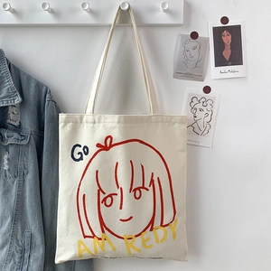 Detailed view of canvas tote bag with artistic girl sketch and colorful graphic prints