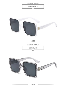Vue détaillée de lunettes de soleil carrées oversize avec branches larges et accents dorés