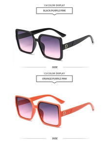 Détail de lunettes de soleil carrées oversize avec verres dégradés et logo D en métal