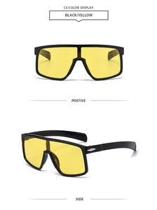 Detail of oversized cycling sunglasses with black frame and transparent yellow lenses