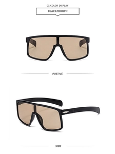 Close-up of oversized black cycling sunglasses with brown lenses and metal diamond accents