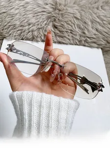 Close-up of frameless sunglasses featuring silver metal star accents on the bridge and hinge