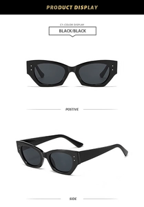 Détail de lunettes de soleil œil-de-chat noires rétro avec des points en métal argenté