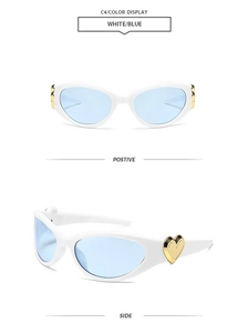Detail of white cat-eye sunglasses with blue lenses and gold heart metal accents
