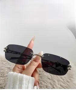 Detail of rimless star sunglasses with nickel metal frame and dark grey lenses