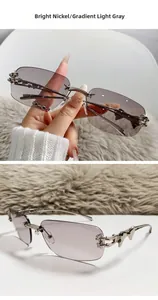 Detail of rimless star sunglasses with nickel metal frame and gradient grey lenses
