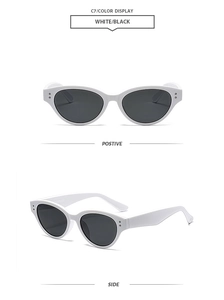 Detail view of white cat-eye sunglasses with metal rivets and black lenses C7