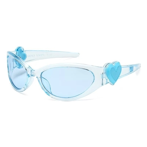 Y2K style light blue translucent sunglasses with heart decor in a 45-degree angle view