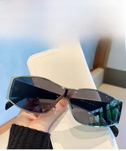 Detail of silver metal oversized sunglasses with grey lenses and white leather pouch