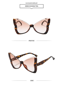 Detail view of butterfly frame sunglasses in demi tea pattern with gradient lenses