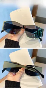 Close-up of golden metal frame sunglasses with grey lenses on white leather texture