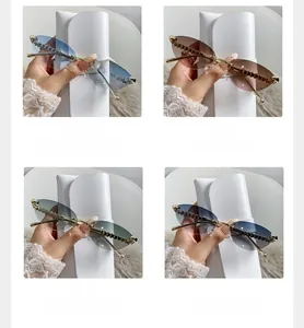 Detailed view of four frameless cat-eye sunglasses with gradient lenses and gold temples