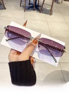 Detail view of purple gradient rimless sunglasses with engraved gear pattern metal temples