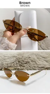 Detail of rimless cat-eye sunglasses with gold metal temples and iconic rockstud studs