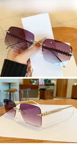 Detail of rimless square sunglasses with golden textured temples and gradient lenses