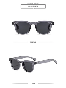 Detail view of square gray translucent sunglasses with silver rivets and dark black lenses