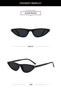 Detail of black cat-eye sunglasses featuring silver rectangular metal accents and narrow frame