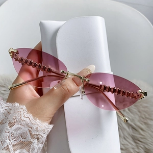 Pink gradient cat eye rimless sunglasses with gold metal temples and geometric textures