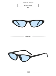 Detail of vintage cat-eye sunglasses with narrow black frames and light blue lenses