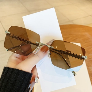 Frameless rimless sunglasses with brown gradient lenses and textured gold metal temples