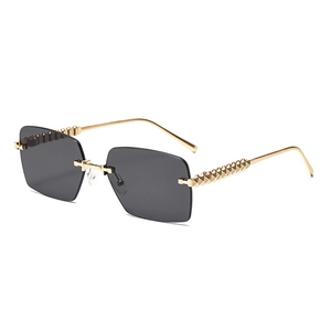 Frameless square metal sunglasses with dark gray lenses and golden pyramid rivet temples