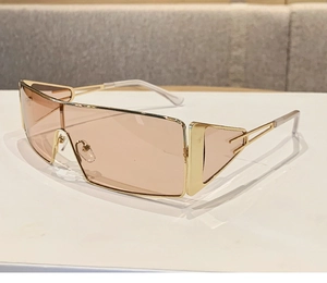 Detail of champagne lens shield sunglasses with elegant gold metal frames and nose pads