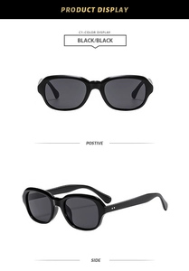 Detail view of stylish black square sunglasses with polished frames and gray lenses