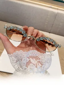 Detail showing gold metal frame with rhinestones and gradient brown oval lenses