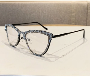 Detail view of stylish cat-eye glasses frame with sparkling rhinestones and black finish