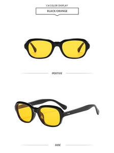Detail of trendy irregular black sunglasses with vibrant orange lenses and silver dots