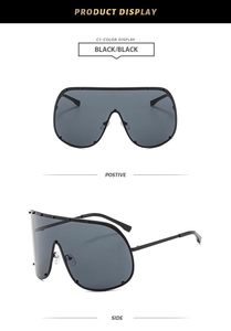 Detail view of black oversized shield sunglasses with silver rivets and sleek side temple