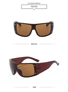 Detail view of tea-colored oversized sunglasses with silver rivets and wrap-around frame