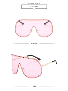 Detail view of pink oversized shield sunglasses with gold metal temples and rivets
